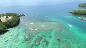 Super Panoramic aerial shots in 4k with the drone in one of the most beautiful beaches in Asia (Bali - Indonesia) Luxurious hotels, holidays, scuba diving, marine flora and fauna, coral reef.