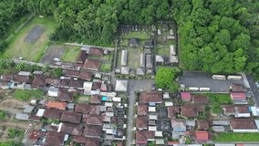 Aerial view of a typical Balinese Hindu village with a sacred temple next to the monkey forest. Culture and tourism. 4k video from above.