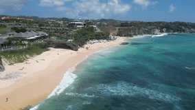 Panoramic aerial 4k 60 fps shot of a beach Dreamland beach, tourist and spectacular beach for swimmers and surfers who love to ride the ocean waves of this island. (Bali, Indonesia).