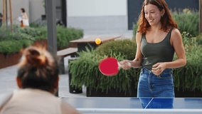 Cheerful young women friends playing ping pong table tennis, having fun together - Powered by Shutterstock - Get 15% off with code: PIKWIZARD15