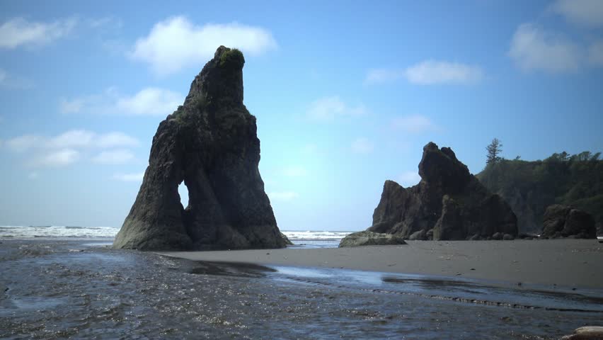 Small river, The coast of the Pacific Ocean, large cliffs and islands near the shore. Olympic NP, Washington USA