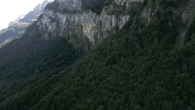 stunning aerial footage of a beautiful mountain range featuring a gorgeous natural landscape with cascading waterfalls provides a breathtaking view of the mountainous environment essence of raw nature