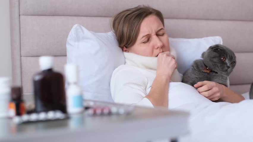A woman has a cold, the flu. Sore throat, cough and fever. Catching cold, having cough. | Shutterstock HD Video #1109613259
