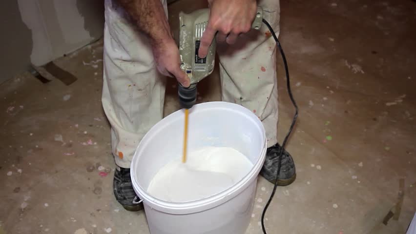 Plasterer Using Power Drill with Mixing Paddle Rod to Mix a Plaster. Mixing Plaster for Drywall Plastering. House Painter at Work. Royalty-Free Stock Footage #1109619759