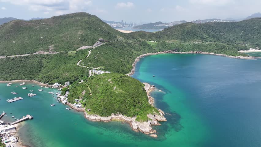 Sai Kung Clear Water Bay Beach in Hong Kong is a serene coastal destination with crystal-clear waters and golden sandy shores. perfect for swimming water sports sunbathing and picnicking