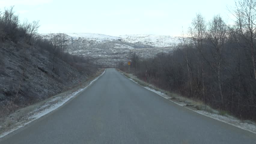 Utsjoki, Finland Late fall and early winter driving conditions on an icy road in Finnish Lapland. 