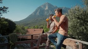 young woman and man, lovely couple having orange juice for breakfast in camping outdoors with great landscape view from terrace. climbing campsite in Turkey, Geyikbayiri, Antalya - Powered by Shutterstock - Get 15% off with code: PIKWIZARD15