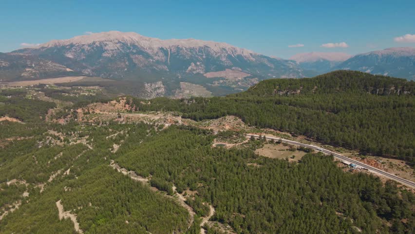 Amazing aerial landscape with mountains, woods on slopes, fields and road in Turkey. Tourism and destinations, beauty on nature in Turkey