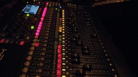 working large sound mixer with buttons and sliders in sound studio, audio equipment