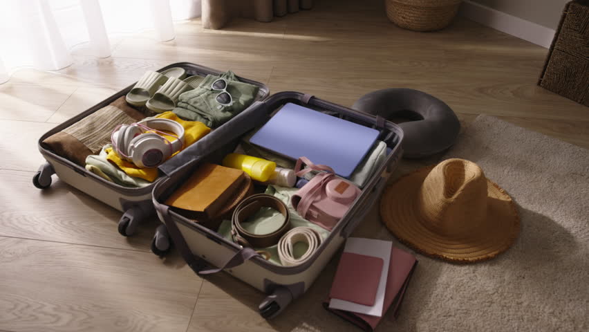 Packed open suitcase with clothes on floor. Preparation, getting ready for journey. Coming soon flight at airport, departure from city on trip, packing suitcases, luggage. Suitcase lies open on floor. Royalty-Free Stock Footage #1109627981