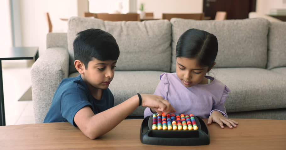 Cute little girl play rainbow balls boardgame with older brother at home. Friendly siblings enjoy IQ board game on leisure in living room. Activity for children cognition, boost concentration, hobby Royalty-Free Stock Footage #1109628261