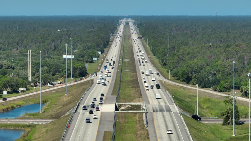 Above view of wide highway in Florida with fast driving cars during rush hour. USA transportation infrastructure concept