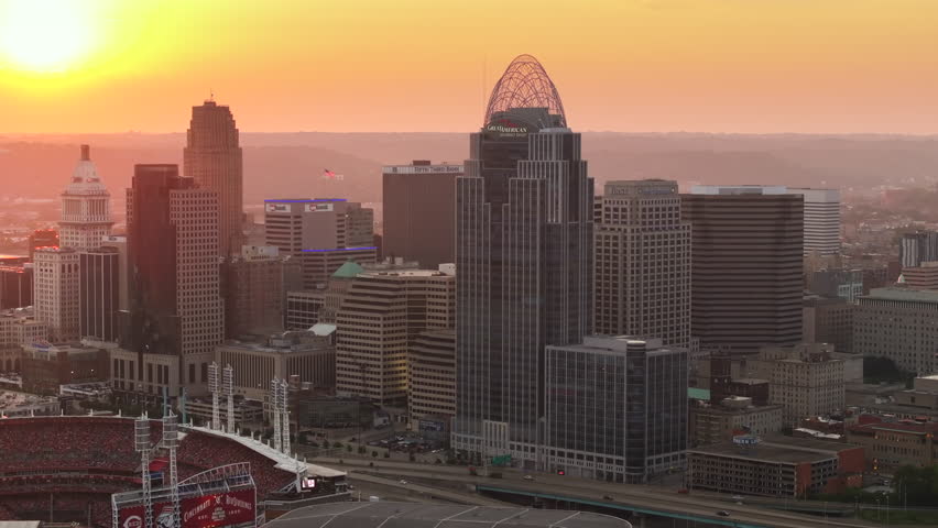 Evening urban landscape of downtown district of Cincinnati in Ohio state, USA. American city skyline with brightly illuminated high commercial buildings.