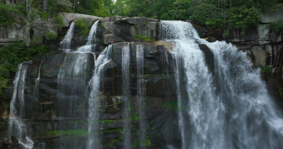 Amazing summer landscape with forest river waters falling down in big waterfall with clear water between rocky boulders in Nantahala National Forest. Whitewater Falls, North Carolina, USA