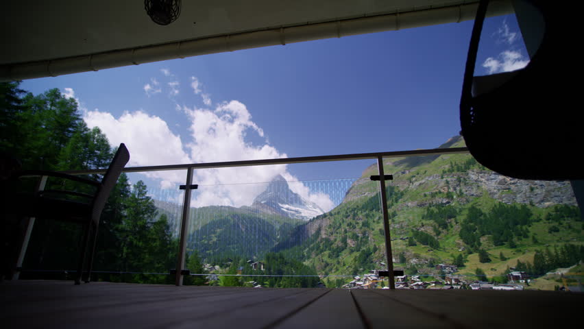 Alpine hiking female with backpack taking photos on camera phone Zermatt Matterhorn before her adventure travel tourism Switzerland