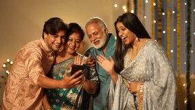 Indian family happily waving and chatting on a video call during Diwali celebrations, colourful decorations.a Hindu festival,diwali festival.standing toghter.