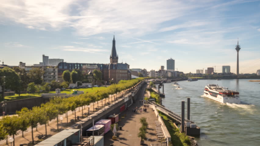 Dusseldorf germany city skyline aerial view time lapse hyperlapse view of city downtown from bridge in front Dusseldorf skyscrapers and old town and river. Royalty-Free Stock Footage #1109643659