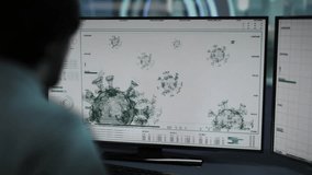 A scientist in a medical gown works on a computer. Modern software for visualization and data analysis. Biomedical Research. Covid-19 detected. Spherical virus covered in protein spikes structure - Powered by Shutterstock - Get 15% off with code: PIKWIZARD15