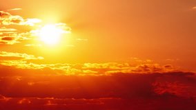 Timelapse Awesome sunset moving down in orange sky with clouds. Bright orange sun moves down over the horizon behind the layered clouds. Epic cloud space, vibrant color. Time Lapse. Beautiful sundown - Powered by Shutterstock - Get 15% off with code: PIKWIZARD15