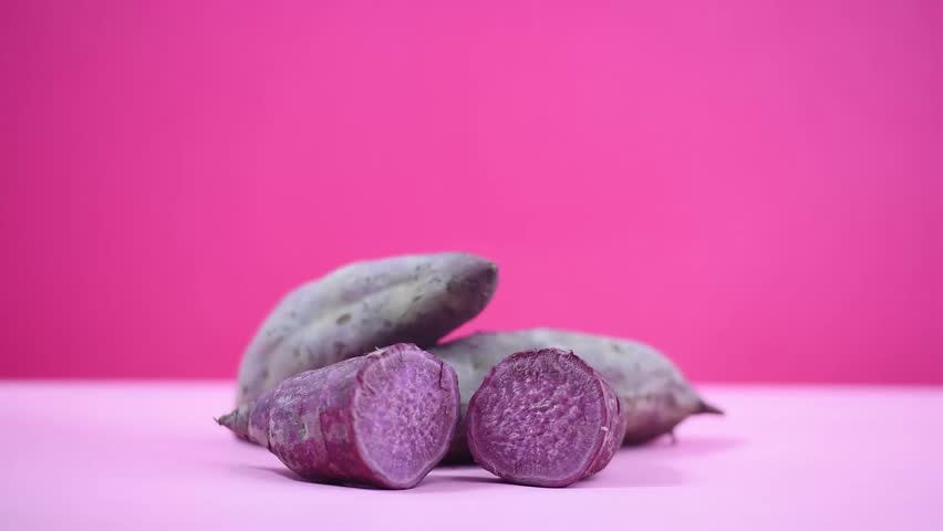 Purple purple sweet potato cut in half is shrouded in white smoke