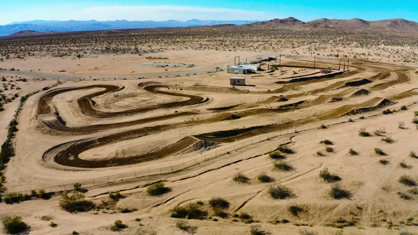 An aerial of a Motor Cross Park in the Mojave Desert on a sunny day under the blue sky