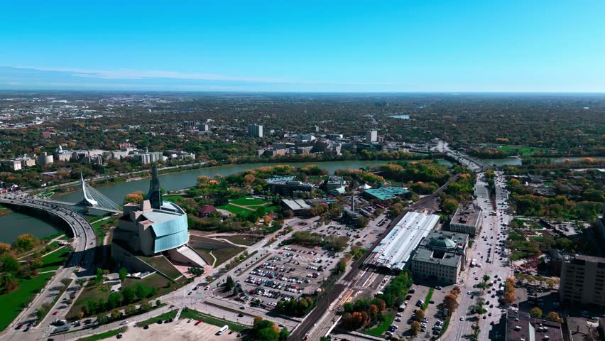 Establishing Shot Fall Seson Drone Aerial Cinematic Shot Fall Downtown Winnipeg Landscape Sky Horizon with VIA Rail Canadian Museum for Human Rights Provencher Bridge The Forks Market Manitoba Canada