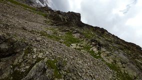 Flying over rough and rugged terrain of Fellaria glacier in Valmalenco, Valtellina in Italy. Aerial drone fpv