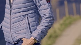 Woman modeling a purple winter jacket, her hands on her jeans - Powered by Shutterstock - Get 15% off with code: PIKWIZARD15