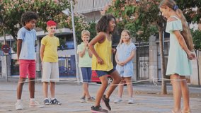 Group of kids playing with chinese jumping rope outdoors. Boys and girls having fun together. - Powered by Shutterstock - Get 15% off with code: PIKWIZARD15
