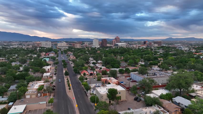 Albuquerque, New Mexico. Aerial shot above houses and homes with street heading towards downtown.