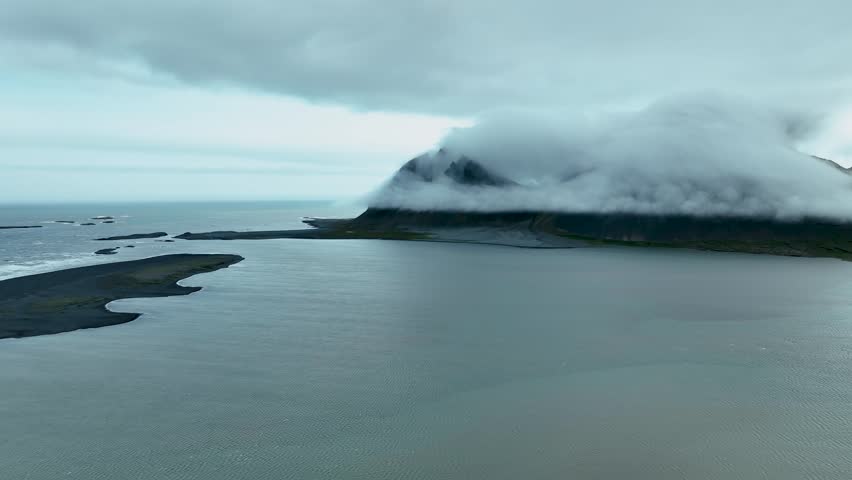 Brunnhorn Mountain Covered In Clouds In East Iceland - aerial drone shot