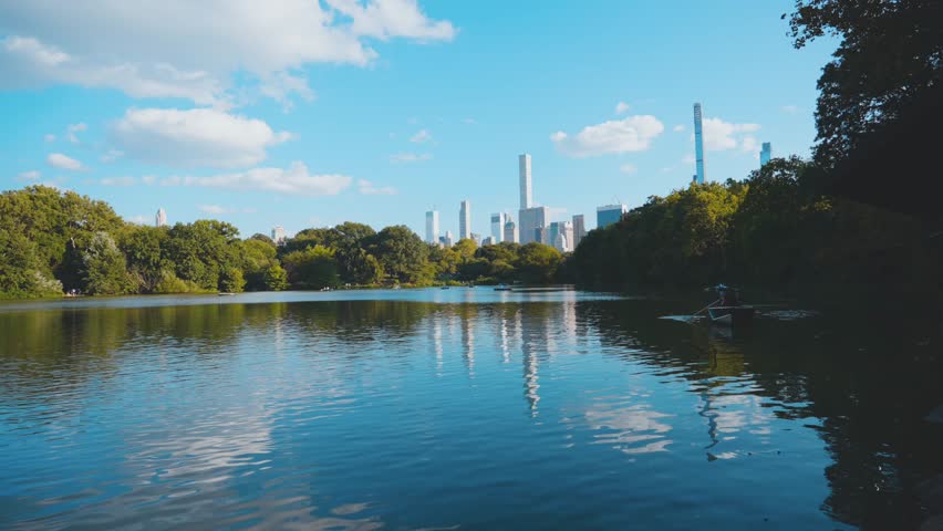 Immerse yourself in the urban oasis of Central Park, New York City, through these captivating videos. Witness the harmonious blend of nature and city life, as skyscrapers frame lush meadows, vibrant f Royalty-Free Stock Footage #1109663191