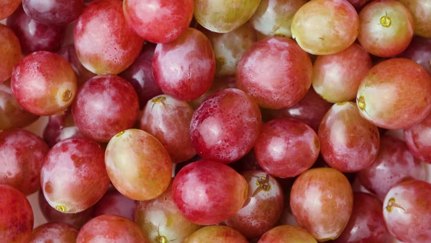 Pink sweet grapes close-up top view