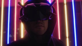 Hooded man in futuristic cyber glasses, portrait with colorful neon illumination, virtual reality, cyberpunk cosplay concept, augmented vision, future style - Powered by Shutterstock - Get 15% off with code: PIKWIZARD15