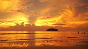 The yellow light pierced the clouds reflecting the water over the sea of Kata Beach Phuket.
Looping video features a beautiful scene with the sun painting the sky above waves.
colorful cloud in sky