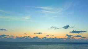 
Aerial hyperlapse view beautiful blue sky above the ocean. 
Scene of colorful yellow rays glistened at sunset. 
creating a beautiful and calming sight. Gradient color. 
abstract nature background