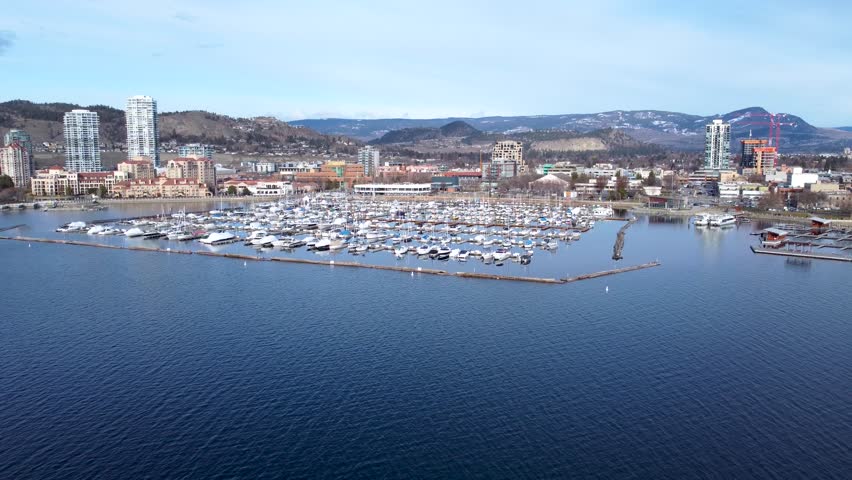Aerial Drone Shot of the Beautiful of City Kelowna British Columbia. Downtown Kelowna Waterfront Catch Club and Boardwalk on a beautiful day.