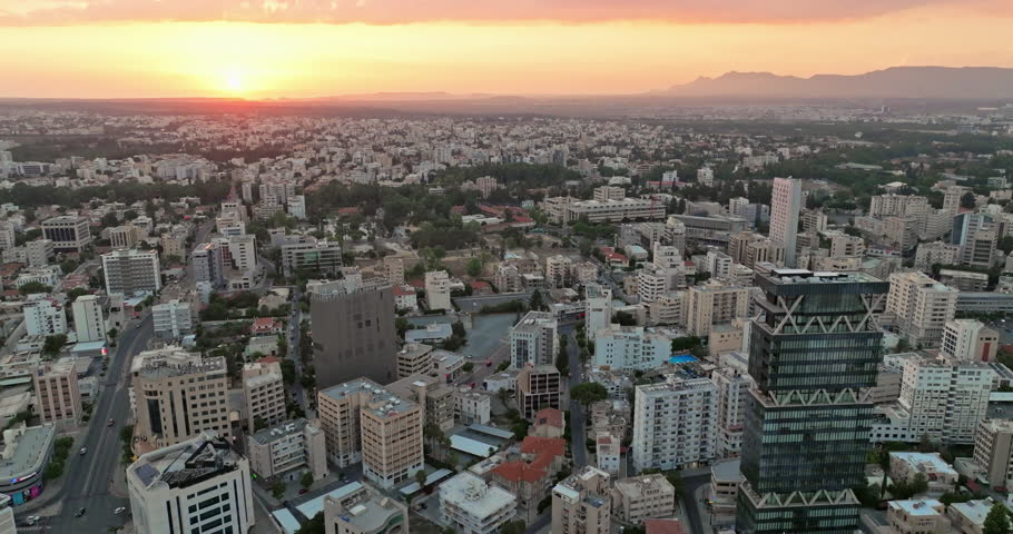 Aerial view of the cityscape of Nicosia, Cyprus. Sunset in an urban landscape with business centers and skyscrapers in downtown. High quality 4k footage Royalty-Free Stock Footage #1109671307