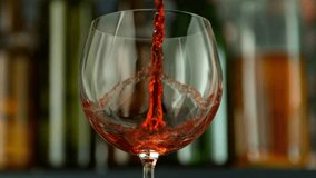 Super Slow Motion of Pouring Red Wine With Camera Motion. Filmed on High Speed Cinema Camera, 1000 fps. Camera Follows the Stream into Glass. Speed Ramp Effect. - Powered by Shutterstock - Get 15% off with code: PIKWIZARD15