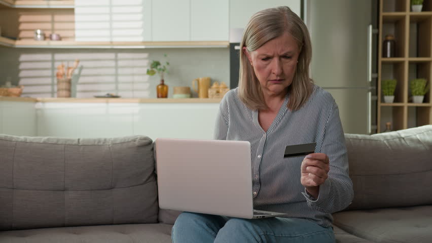 Mature caucasian woman retired senior lady dissatisfied client experiencing problem on laptop with online payment failure bank credit card error mistake unsuccessful transaction trouble wrong password Royalty-Free Stock Footage #1109673929