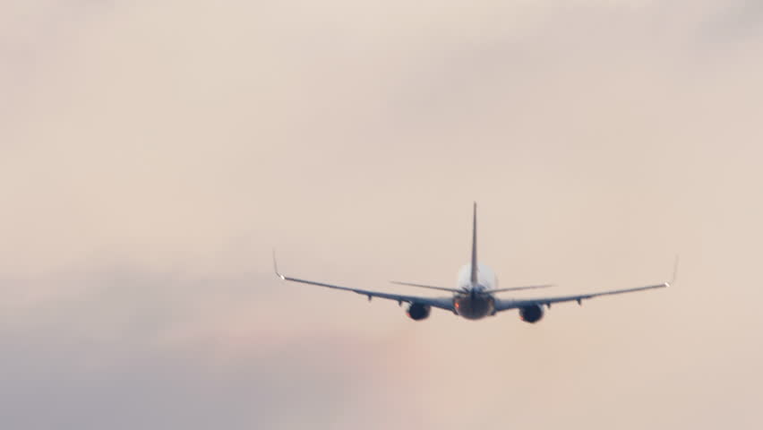 Jet passenger aircraft departure, rear view. Background sky and plane. Airplane takes off, climbing