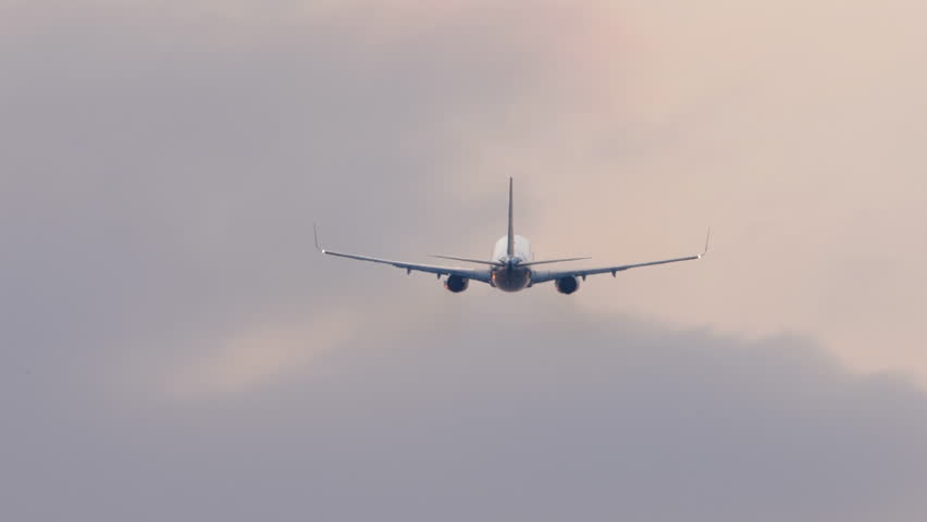 Jet passenger aircraft departure, rear view. Background sky and plane. Airplane takes off, climbing