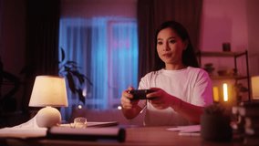 Portrait of young beautiful asian woman relaxing at home playing a video game indoors Holographic video game with augmented reality