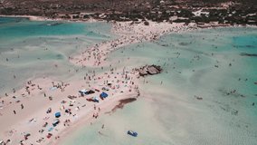 Elafonisi Beach famous for its pink sand filled with tourist during summer holidays. Greek sea and beaches concept. Aerial view. High quality 4k footage
