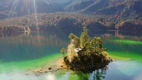4k drone forward video (Ultra High Definition) of Eibsee lake with Zugspitze mountain hill on background. Gorgeous autumn scene of Bavarian Alps, Germany. Beauty of nature concept background.