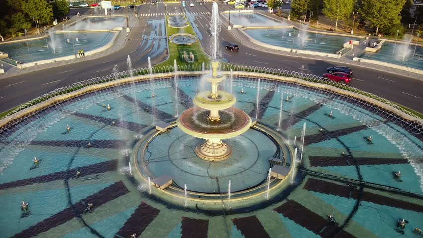 High angle drone footage of the Bucharest fountains at Piata Unirii. Union square seen from above in 4k. Beautiful summer cityscape aerial shot.  Royalty-Free Stock Footage #1109690943