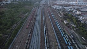 High angle aerial footage of a train terminal at an European port. Drone video in 4k of trains and train cars with cargo and containers ready to be unloaded at the black sea port of Constanta.