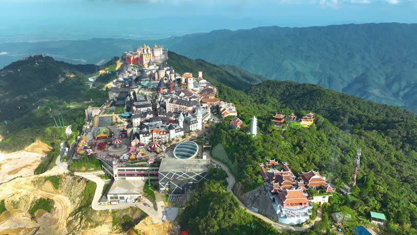 Aerial view of Ba Na Hills, lunar castles and French village with beautiful castles buildings, streets and campuses at the famous tourist destination of Da Nang, Vietnam. Near Golden bridge. Royalty-Free Stock Footage #1109693729