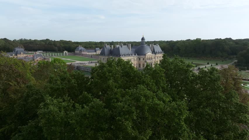 Drone Shot of Vaux-le-Vicomte castle. It is a Baroque French castle located in Maincy, near Melun, 55 kilometres southeast of Paris in the Seine-et-Marne department of Ile-de-France.  Royalty-Free Stock Footage #1109702421
