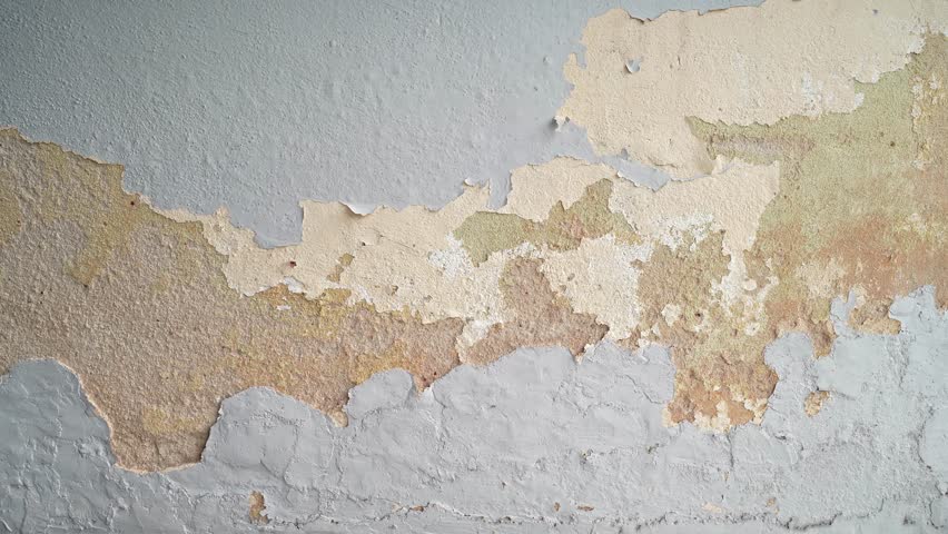 Close-up view of the wall paint peeling off.